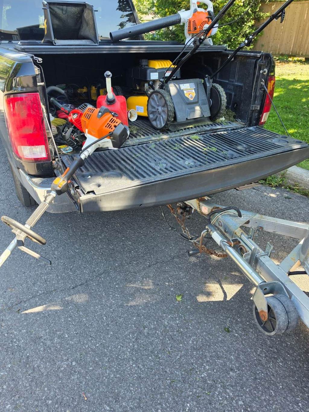 Benny's Lawn Care work truck loaded with a mower, string trimmer and blower on an Ottawa job